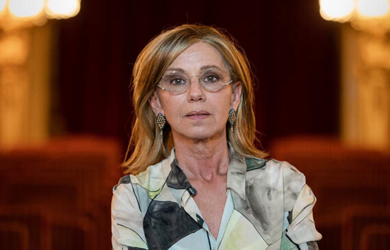 Fotografo di eventi ritratto di Concita de Gregorio, a braccia conserte con lo sfondo del Teatro Carignano