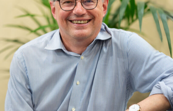 Alessandro Barbero in posa e sorridente su una poltrona