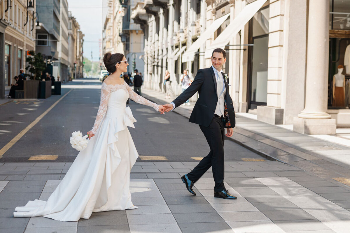 a couple of spouses walks in turin city centre during their wedding