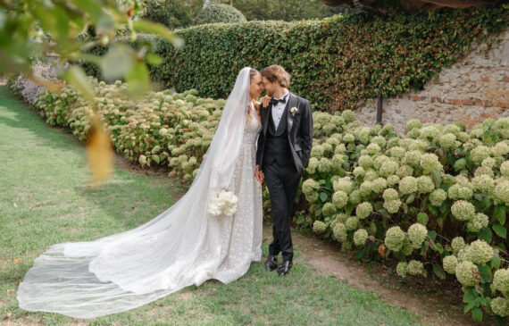 A couple of newlyweds poses for a destination wedding photographer in Italy